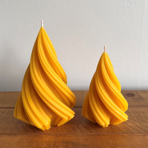 Pointed, twisting, beeswax candles.